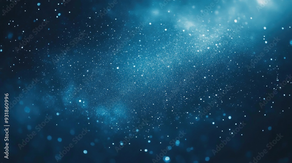 Fototapeta premium Blue background with tiny stars scattered, giving a night sky effect