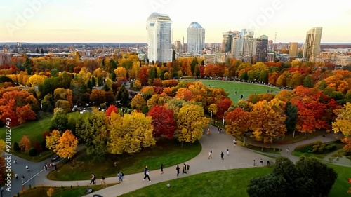 Autumn colors in the park with city skyline views in Montreal in late afternoon
