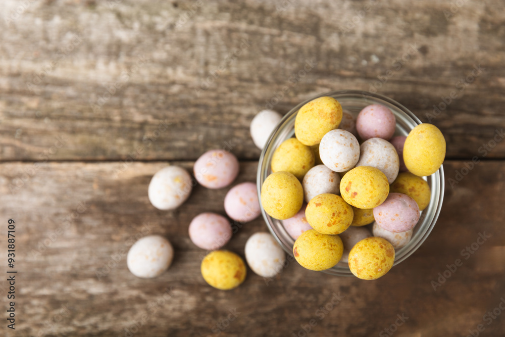 Easter chocolate egg on textured background. Easter celebration concept. Easter chocolate rabbit. Chocolate sweet eggs. Candies on textured wooden table. Space for text.Copy space. Gift. Banner.