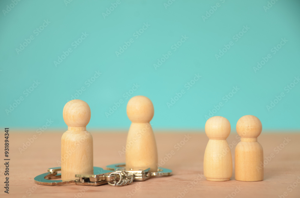 the potential for conflict or division, represented by the handcuffs restraining two members of the family group. the potential for conflict or division, represented by the handcuffs restraining two members of the family group.