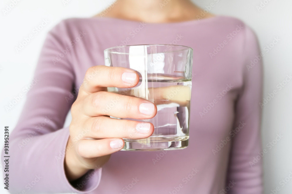 A woman gives a glass of water on a white background A woman gives a glass of water on a white background
