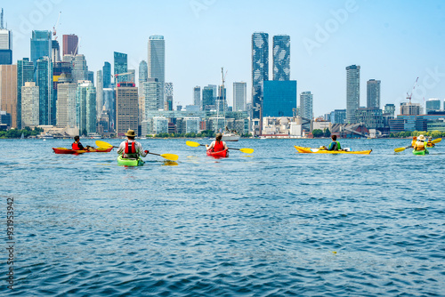 healthy active urban lifestyle: sea kayakers on toronto's inner harbour with the city skyline in the background room for text