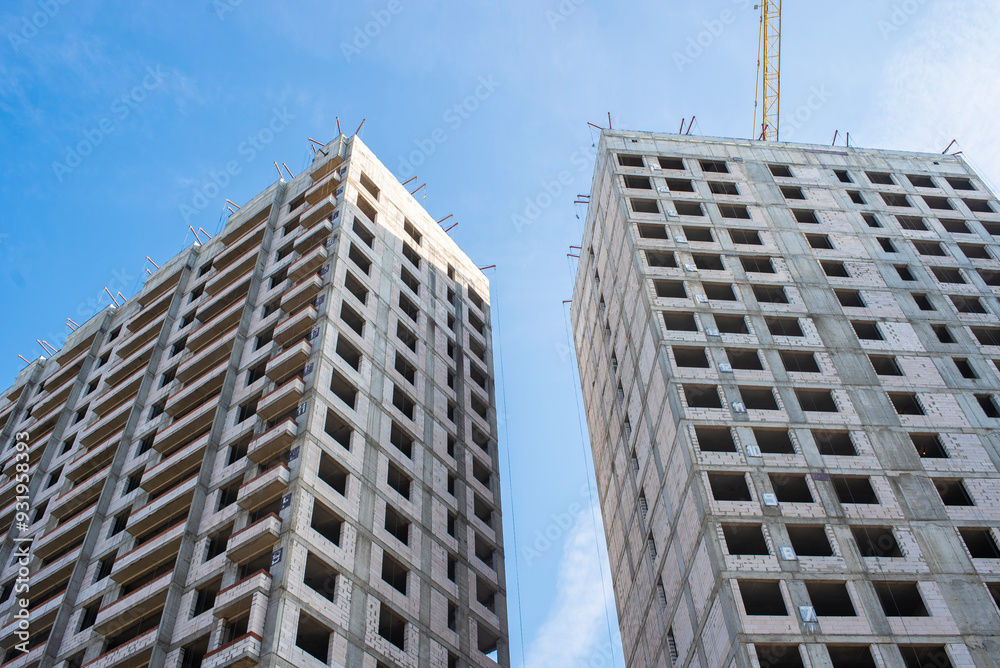 construction of new residential buildings. buildings under construction against the blue sky. construction of new residential buildings. buildings under construction against the blue sky.