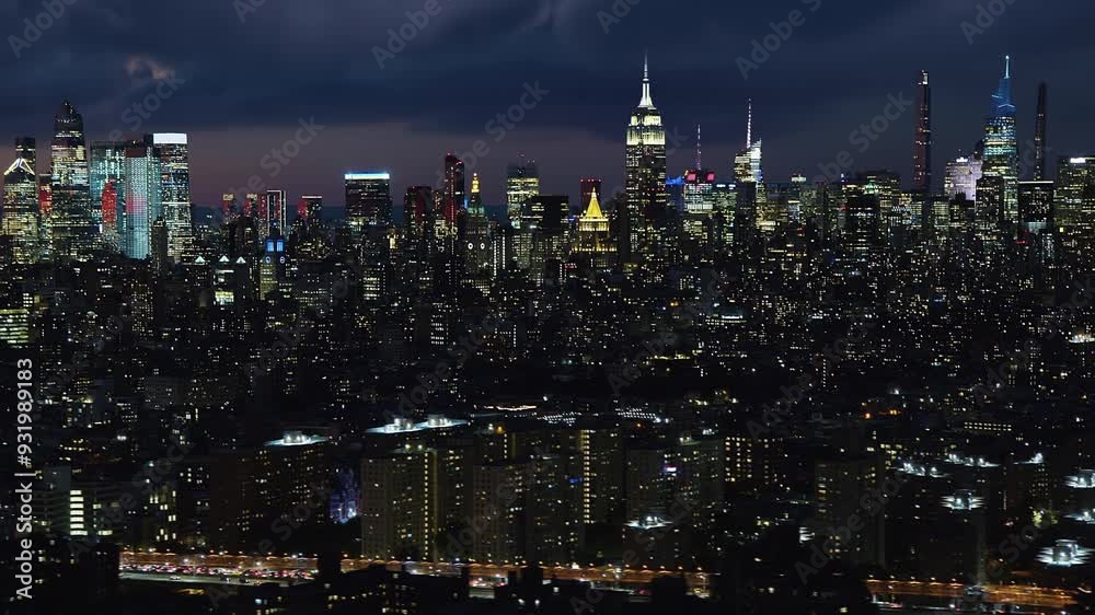 


Aerial View New York City Skyline At Night With Skyscrapers And City Lights Piercing Through The Night.  Flight Through Moving Cloudscape. High Quality Helicopter Footage. United States.           