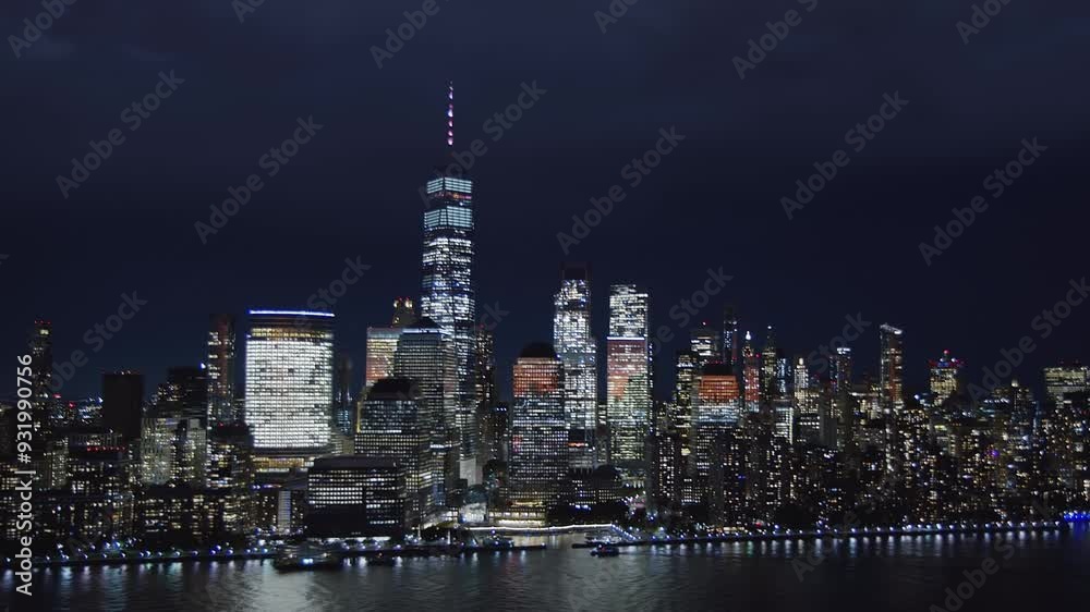 
Aerial View New York City At Night. Flight Through Moving Cloudscape Over Night City Lights. Famous Bright Skyscrapers In Midtown And Lower Manhattan. East River. High Quality Helicopter Footage. 