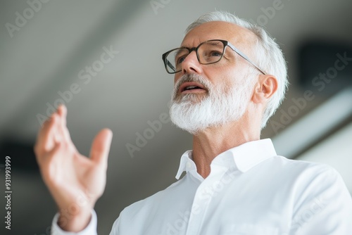 Senior Male CEO Leading Discussion on Workforce Diversity with Employees, Side View