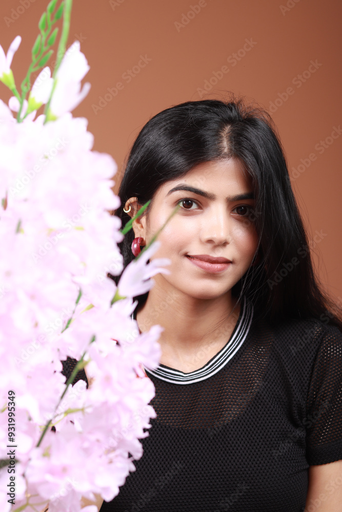 Portrait of a beautiful Indian young woman smiling and wearing casual clothes and looking happy. cute cheerful happy teen student wearing denim jeans outfit looking at camera standing isolated. Portrait of a beautiful Indian young woman smiling and wearing casual clothes and looking happy. cute cheerful happy teen student wearing denim jeans outfit looking at camera standing isolated.