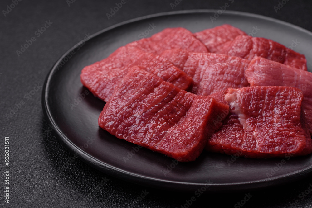 Juicy fresh raw beef meat with salt, spices and herbs Juicy fresh raw beef meat with salt, spices and herbs