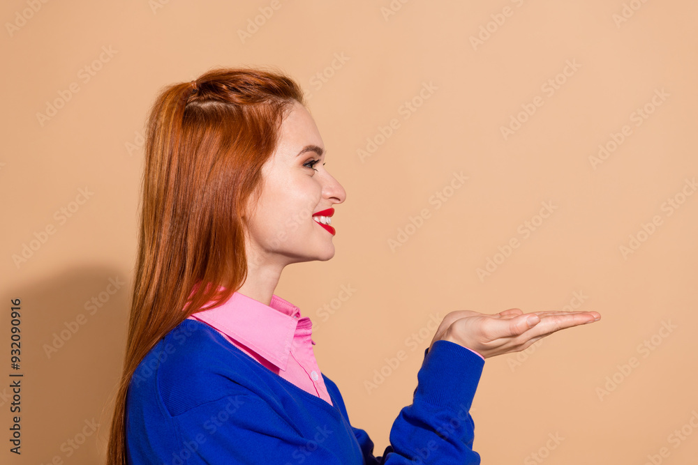 Photo of funny good mood lady dressed pink shirt holdig arms empty space isolated beige color background Photo of funny good mood lady dressed pink shirt holdig arms empty space isolated beige color background