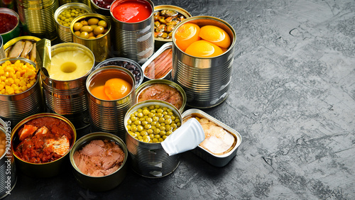 Obraz na plátně Assortment of canned preserves food in tin open cans: fish, beans, vegetables and fruits