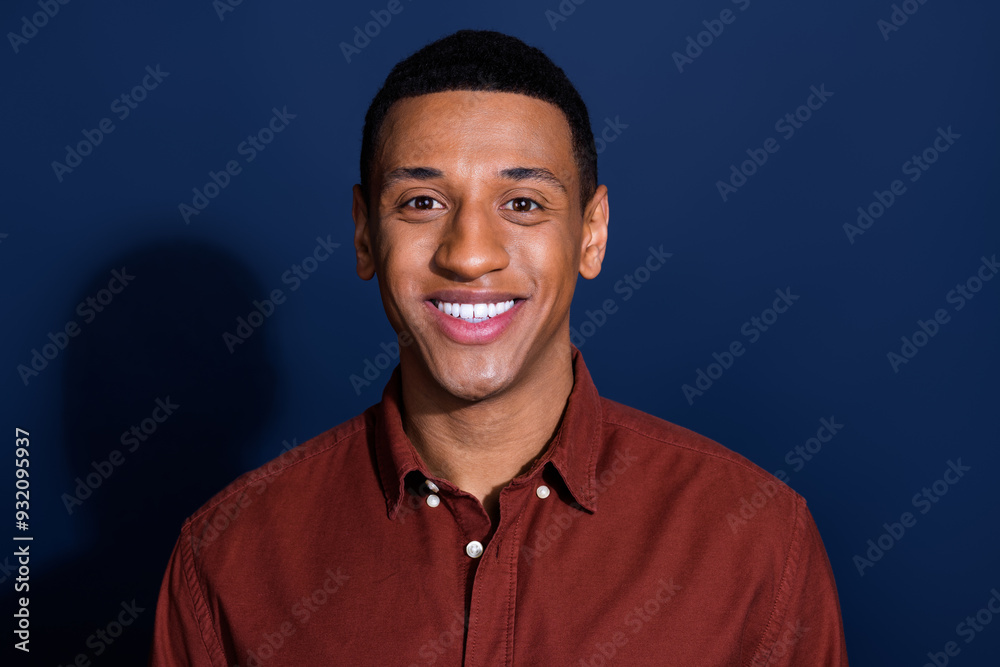 Φωτογραφία Portrait of young man beaming smile wear brown shirt isolated on dark blue color
