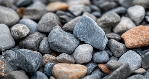 Collection of smooth river stones in various shades on a natural surface