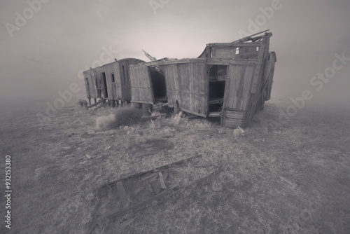 Abandoned Vintage wooden train wagons in a foggy field, Australia photo