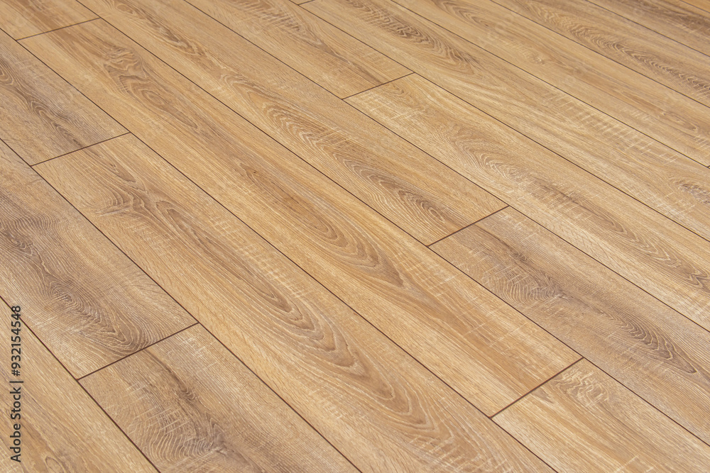 Wooden natural laminate on floor. Laying laminate flooring. Laminate laying scheme