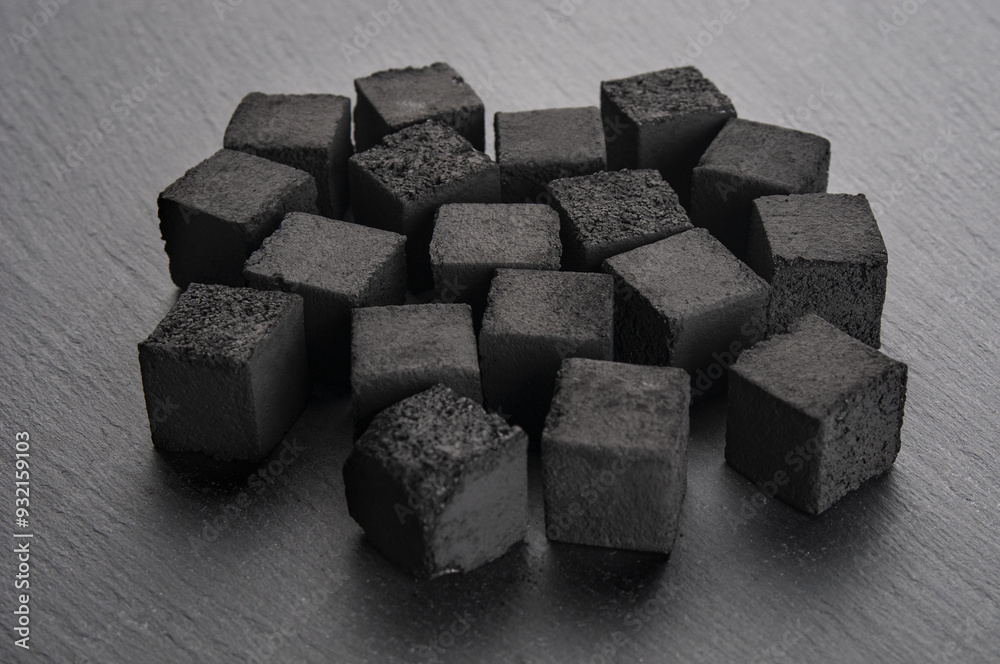 Pile of charcoal cubes for hookah on black background Pile of charcoal cubes for hookah on black background