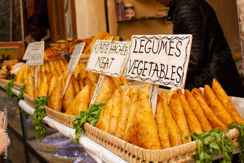 Street food in Morocco selling a variety of samosas. French and English signs. photo