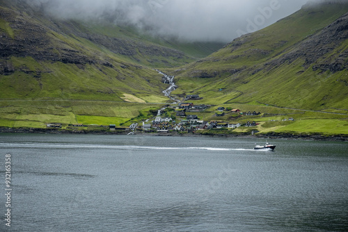 A small village nestled in the green mountains of the Faroe islands, Denmark