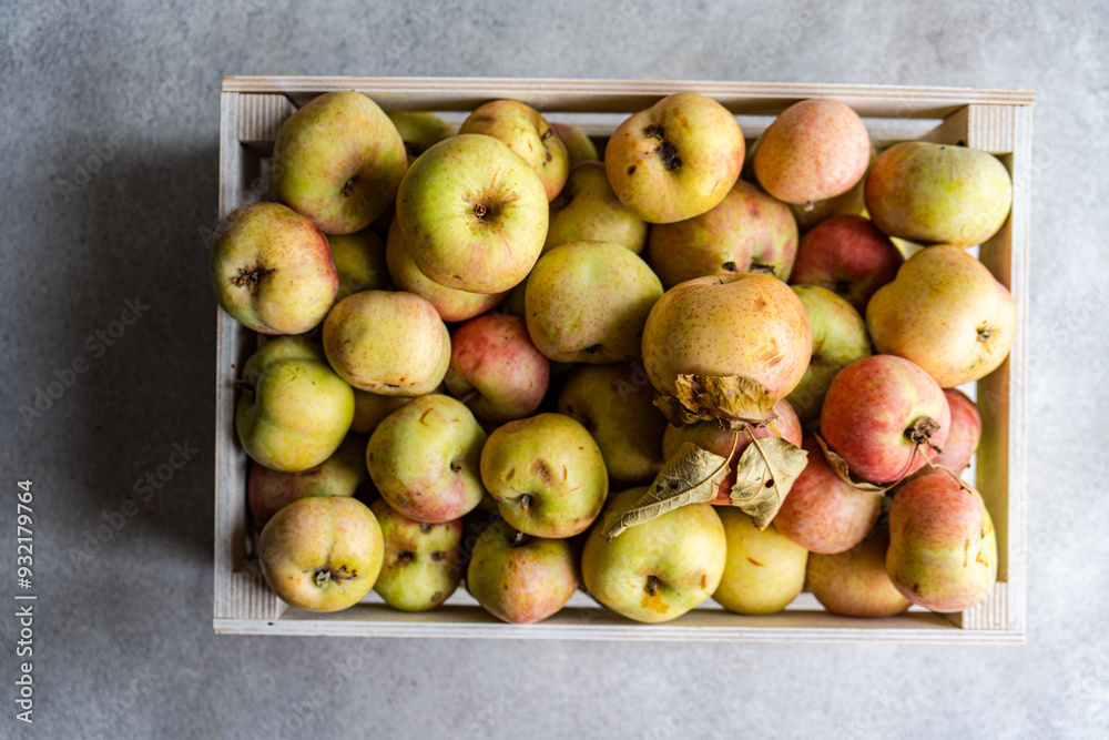 Overhead view of freshly harvested organic apples in a wooden crate Overhead view of freshly harvested organic apples in a wooden crate