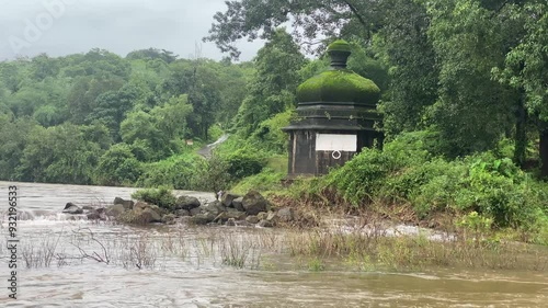 river waters near the temple at sangameshwar in Konkan, Maharashtra swell during the monsoon season photo