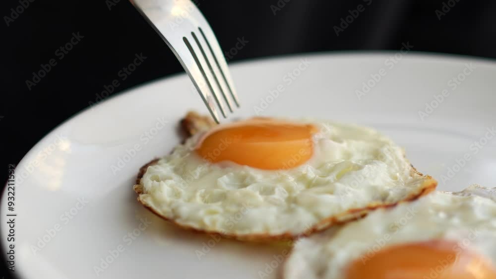 Pierce the yolk with a fork.
The liquid flows out onto the plate.
Fried egg on a plate Pierce the yolk with a fork.
The liquid flows out onto the plate.
Fried egg on a plate