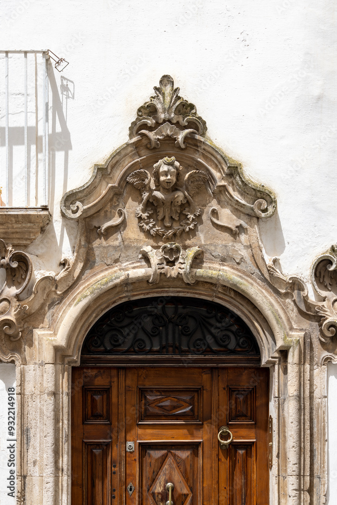 Portal above the door of a tenement house, a typical sight in narrow streets in Mediterranean countries, Martina Franca, Italy, Apulia