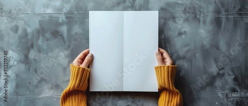 Female hands holding blank magazine gray background design template. Mockup image