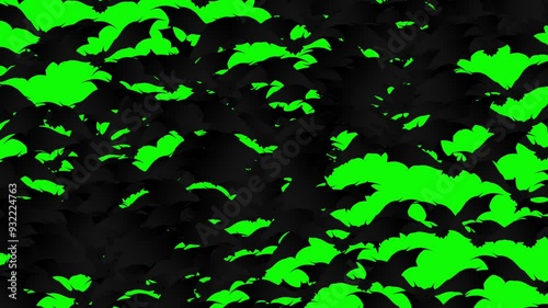 A large swarm of Halloween bats flying and filling the green screen