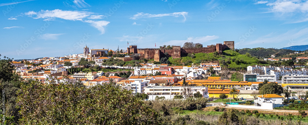 View of Silves town buildings with famous castle and cathedral, Algarve region, Portugal View of Silves town buildings with famous castle and cathedral, Algarve region, Portugal