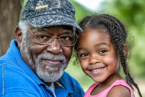 Inclusion & diversity in young families. Black father hugging disabled daughter in wheelchair.