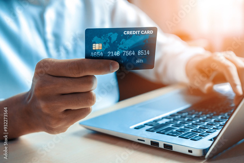 Young man use credit card for shopping payment online on laptop computer application or website. E-commerce and online shopping concept. uds