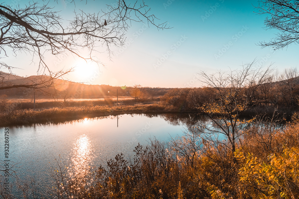 A peaceful autumn sunset over a lake in the forest. A feeling of coziness, calm, happiness, freedom and relaxation. An escape from the hustle and bustle. A peaceful autumn sunset over a lake in the forest. A feeling of coziness, calm, happiness, freedom and relaxation. An escape from the hustle and bustle.