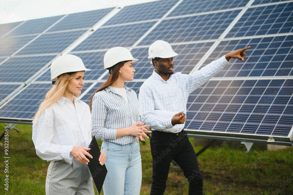 A team of professional engineers are working on a solar panel farm A team of professional engineers are working on a solar panel farm