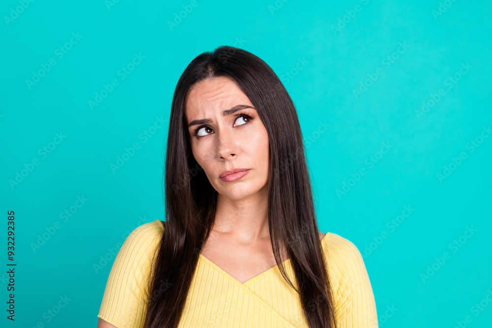 Photo of nice young woman look empty space wear top isolated on teal color background Photo of nice young woman look empty space wear top isolated on teal color background