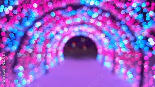Bokeh light tunnel with pink and blue lights, creating a dreamy effect.