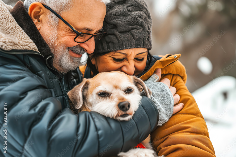 Obraz premium Elderly couple cuddling their dog in a snowy park on a winter afternoon