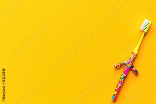 Colorful Cartoon Toothbrush on Vibrant Yellow Background - Dental Care, Hygiene, Fun for Kids photo