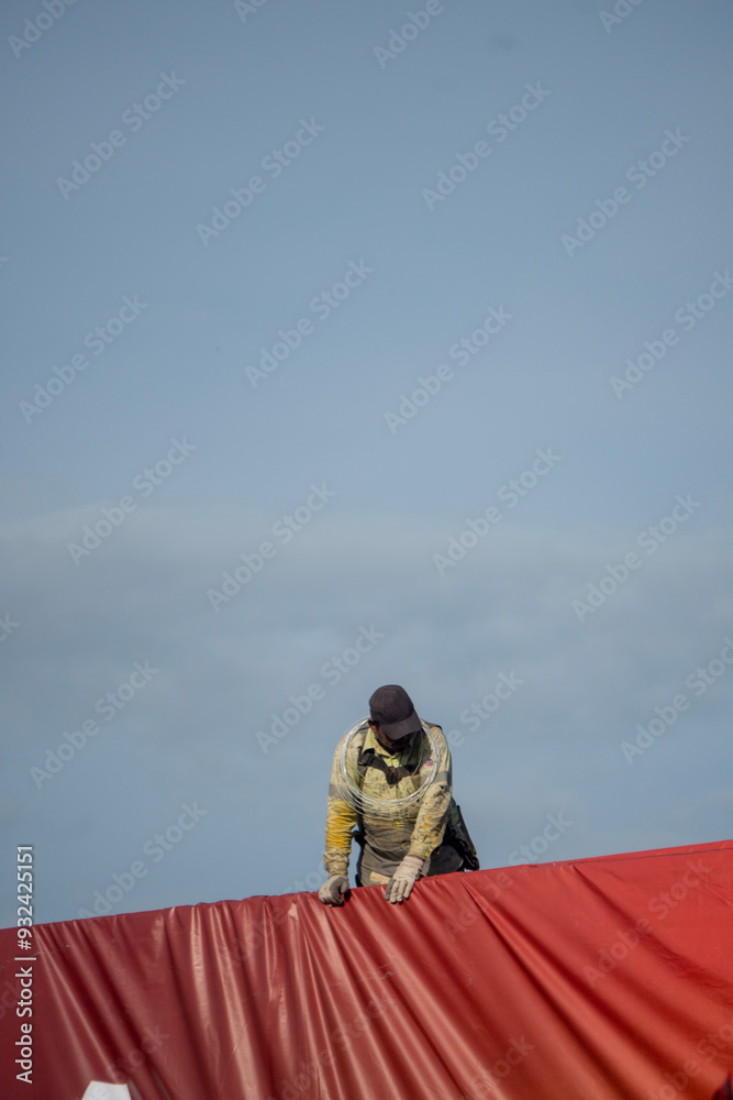 Obraz premium Installation of a large advertising banner on a publicity fence structure