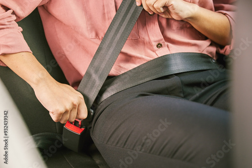 Person, car and seatbelt for safety, driving and travel in ehailing service for destination or road trip. Passenger, transport and journey for protecting with satisfied, happy and ready in taxi ride photo