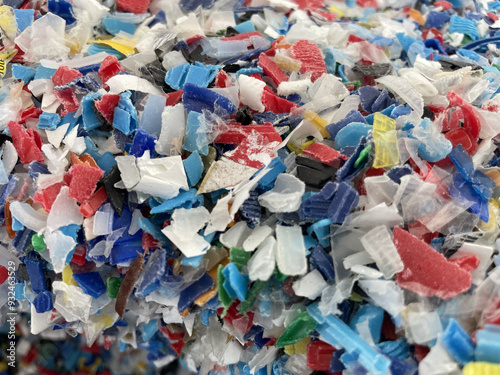 Closeup image of colorful plastic flakes. Concept pollution, environment, save the planet. PP plastic recycling from bottles. Bottle cap. PET bottle recycled. High quality photo