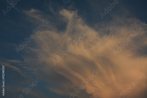 Yellow evening clouds in blue sky, background