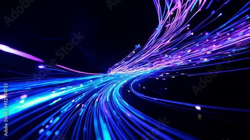 Illuminated fiber optic strands swirl in darkness. Vibrant blue and purple light trails create a sense of speed and connectivity.