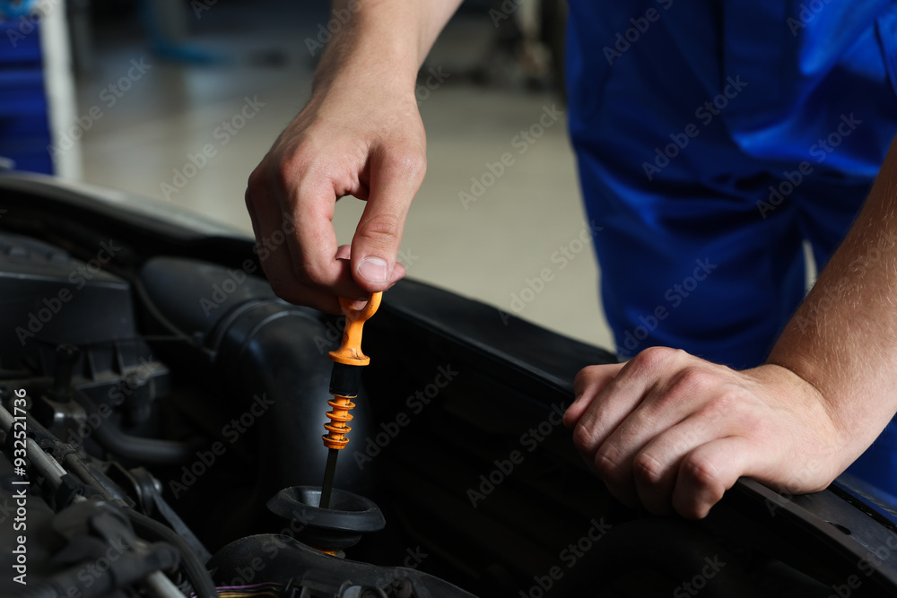 Auto mechanic fixing car at automobile repair shop, closeup Auto mechanic fixing car at automobile repair shop, closeup