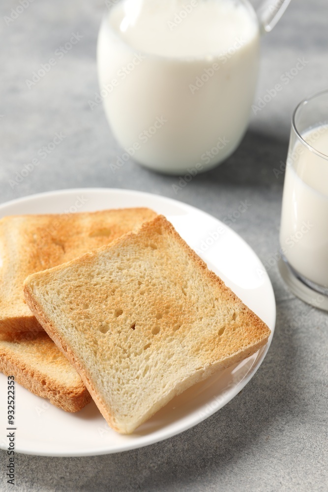 Delicious toasts with milk on light table, closeup Delicious toasts with milk on light table, closeup