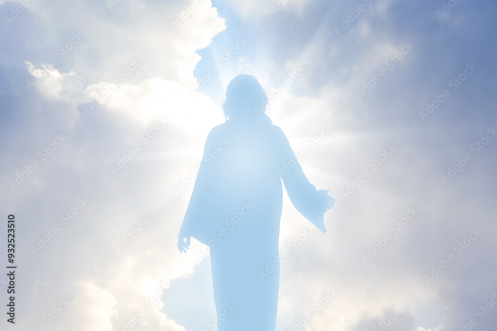 Silhouette of Jesus Christ in sunlight among clouds in sky Silhouette of Jesus Christ in sunlight among clouds in sky