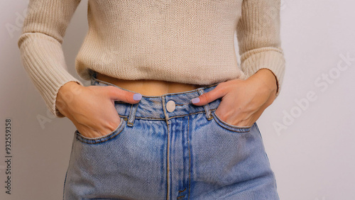 Closeup of Young Woman in High Waisted Jeans and Cropped Sweater