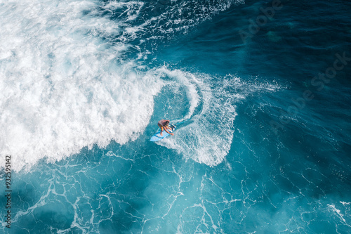 High angle aerial view of people surfing in Bali, Indonesia