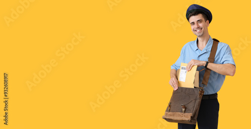 Handsome young postman on c...