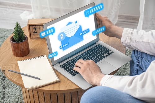 Man using laptop to check e...