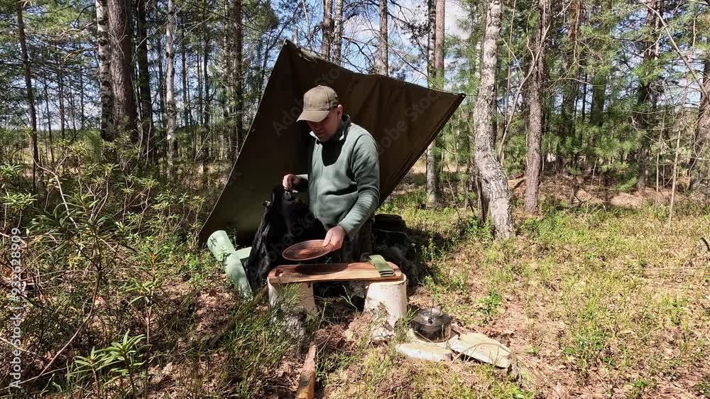 A tourist hid under a canopy in the forest A tourist hid under a canopy in the forest