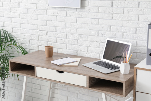 Workplace with laptop, stat...